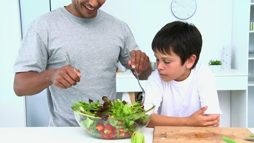 man-preparing-salad-with-son.jpg