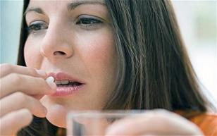 woman-holding-a-glass-of-water-and-pills.jpg