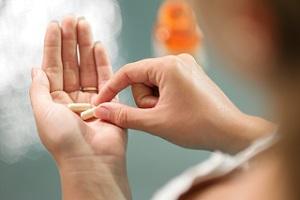 woman-holding-vitamin-capsules.jpg