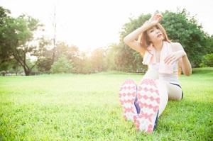 asian-woman-are-tired-sitting-on-the-lawn.jpg