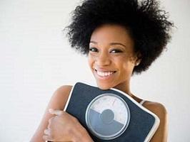 smiling-woman-holding-weighing-scale.jpg