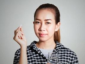 woman-holding-pill-and-glass-of-water.jpg