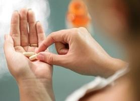 photo-of-woman-holding-supplements.jpg