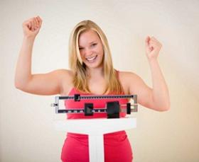 photo-of-a-happy-woman-on-weighing-scale.jpg