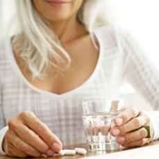 photo-of-a-woman-holding-a-glass-of-water-and-supplements.jpg