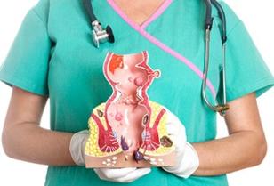 a-doctor-holds-a-model-of-the-human-rectum-showing-internal-and-external-hemorrhoids.jpg