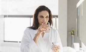 photo-of-woman-holding-glass-of-water-and-bottle.jpg