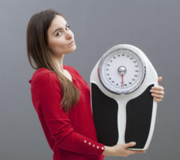 photo-of-a-woman-weighing-scale.jpg