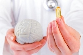 Doctor Holding Omega-3 Supplements and Brain Figure