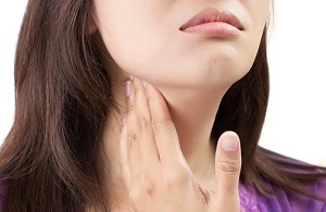 Woman Pressing her Thyroid Gland