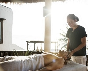 woman massaging men's head