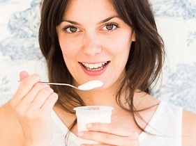 Woman Holding Cup of Yogurt for UTI