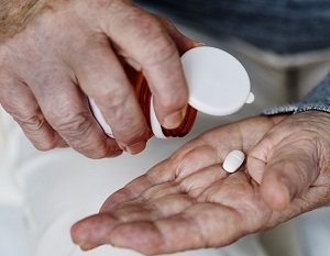 Man Holding Bottle and Supplements