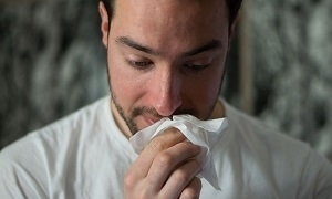 man wiping mouse with tissue paper