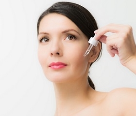 Woman Applying Serum on Face