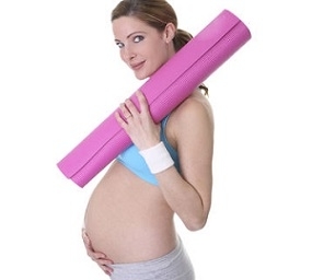 Pregnant Woman With Yoga Mat