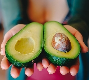 Holding Fresh Sliced Avocado