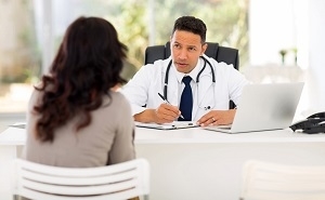 Woman Consulting with Male Doctor
