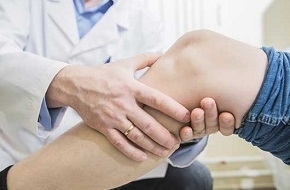 Doctor Examining Leg with Deep Vein Thrombosis