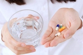 Photo of Woman Holding Glass of Water and Pills